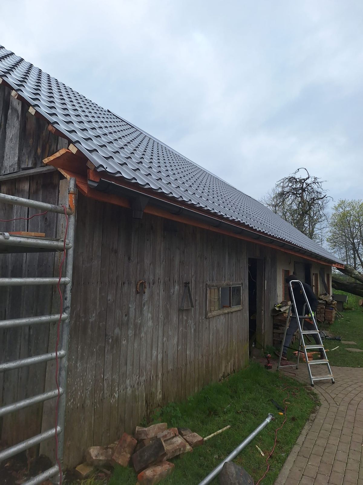 Ēkas koka daļa ar jauno jumtu